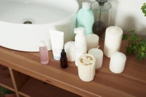 light-colored-bathroom-sink-tubes-cream-jars-facial-serums-clean-towels-concept-skin-care-washing-201474666