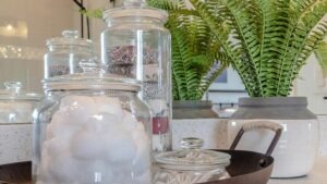 panorama-plant-tray-jars-soap-cotton-balls-buds-bathroom-countertop-wall-mirror-reflects-round-shower-head-186964222