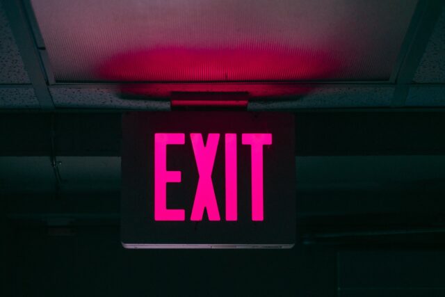black and pink Exit signage