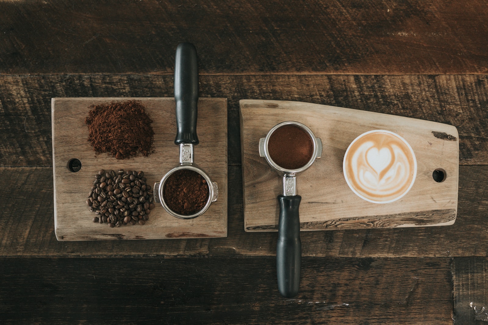 What makes a good coffee? coffee beans beside coffee powder on brown wooden board