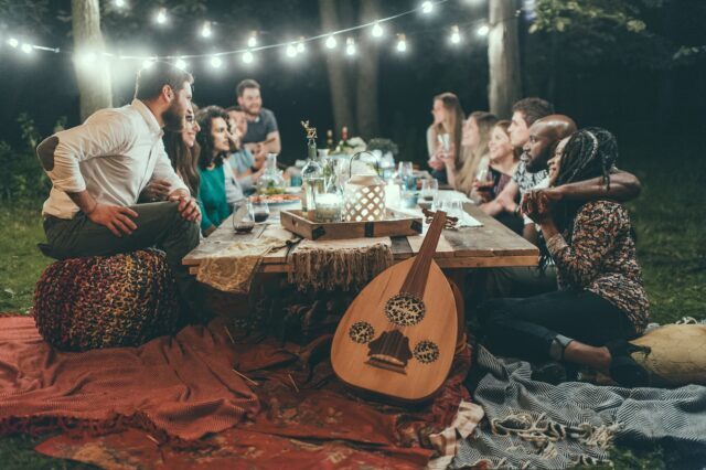 5 Tips For a Successful Outdoor Party people sitting on chair in front of table with candles and candles