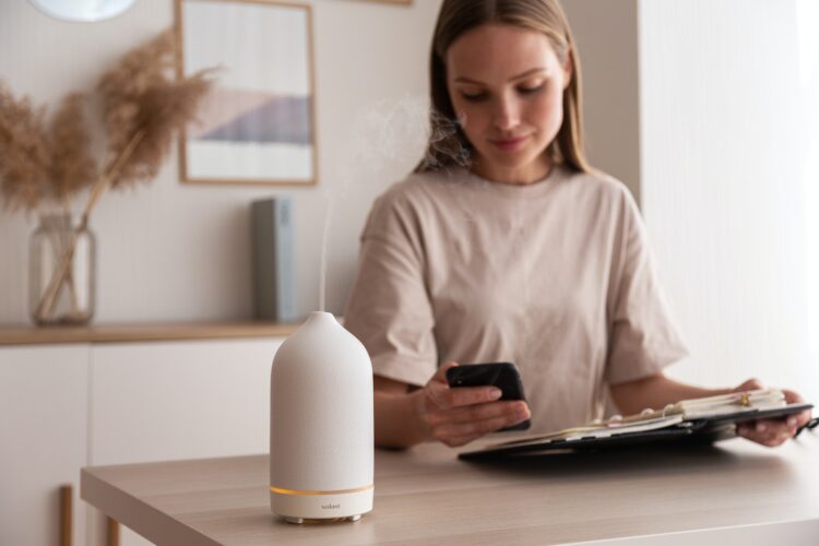 a woman sitting at a table looking at her phone