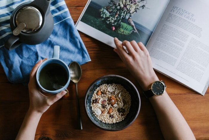 Is Your Morning Routine Missing This Secret Ingredient for Success? person holding blue ceramic mug and white magazine
