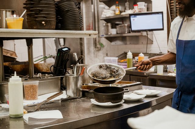a man standing in a kitchen preparing food