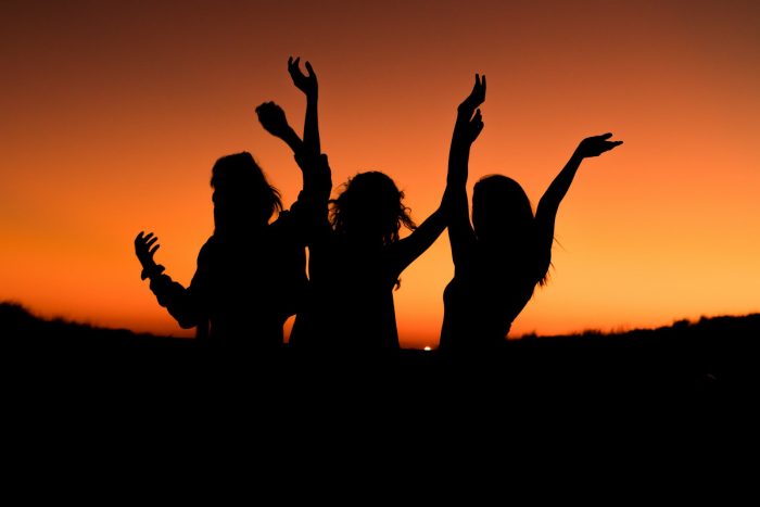 Simple Steps to Make Big Life Changes with Minimal Effort silhouette of three woman with hands on the air while dancing during sunset
