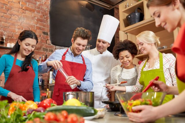 5 Tips for Choosing the Best Outdoor Cooking Grills cooking class, culinary, food and people concept - happy group of friends and male chef cook cooking in kitchen
