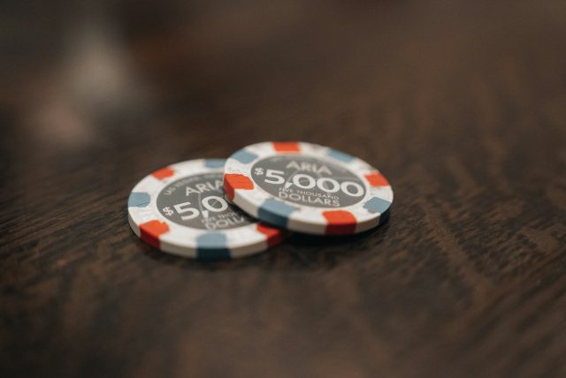 Small Bets, Big Bets and the Difference Between Them two poker chips sitting on top of a wooden table